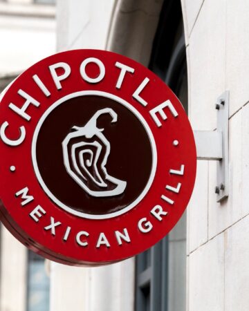 Round sign of Chipotle Restaurant on a wall.