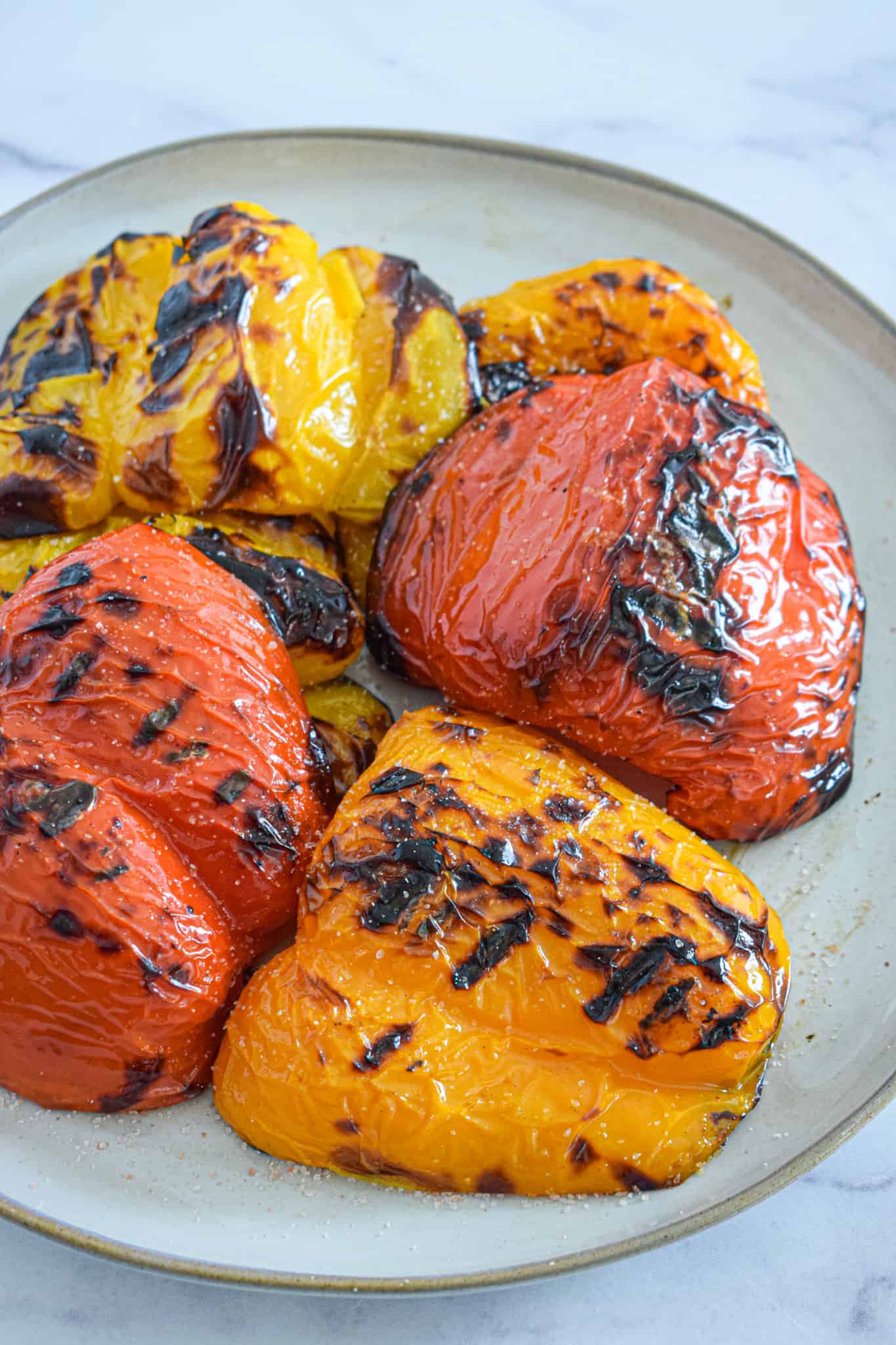 Grilled bell peppers, a healthy summer side dish, on a plate.