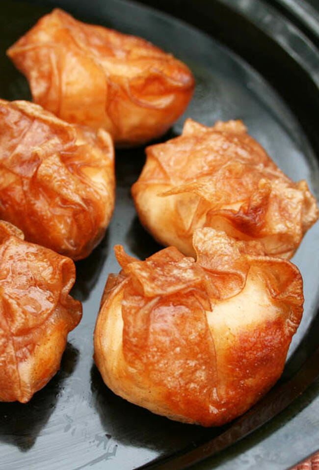 Crispy brown packets in a black surface.