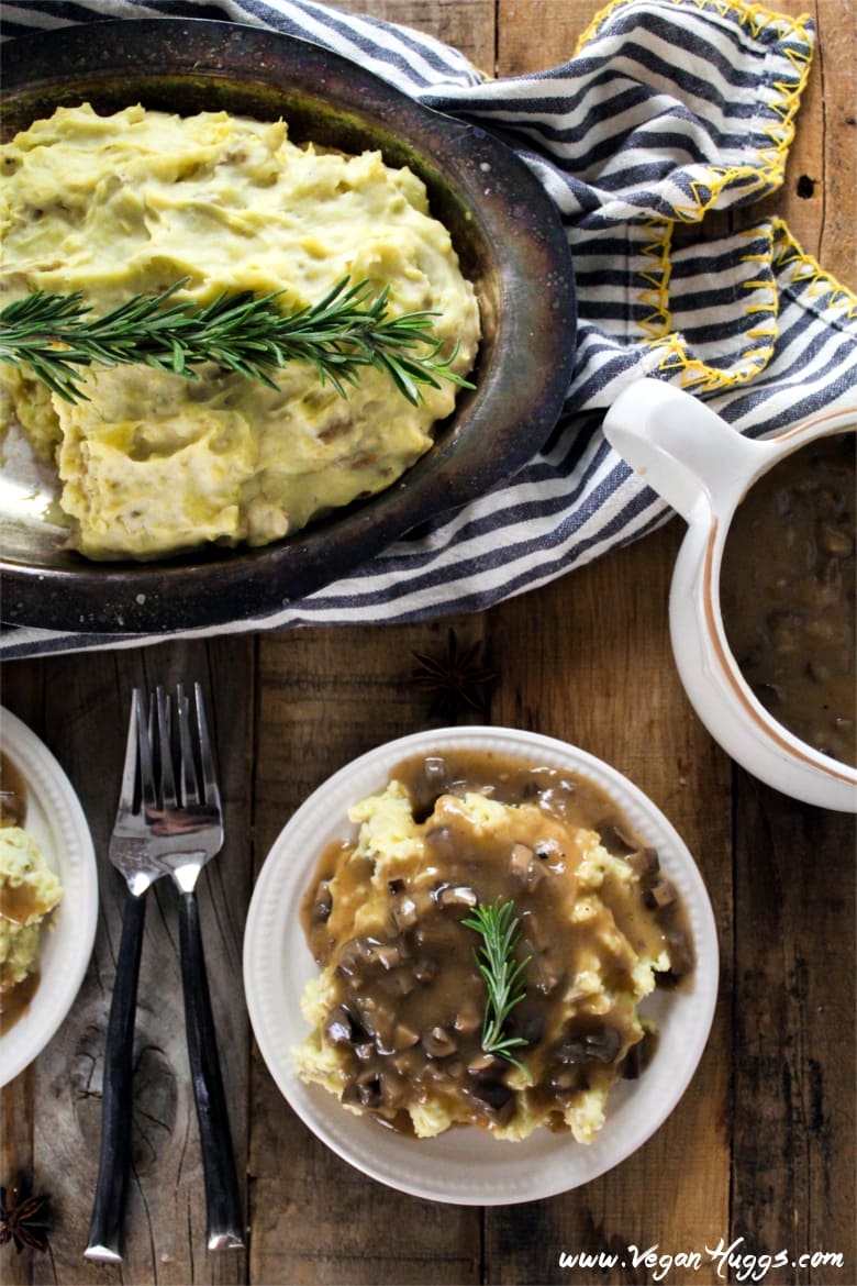 Mashed Potatoes & Mushroom Gravy overhead shot. Gravy boat on the side. / Bring on the dreamy Mashed Potatoes & Mushroom Gravy! This classic recipe is so easy to make, super creamy, comforting and vegan.